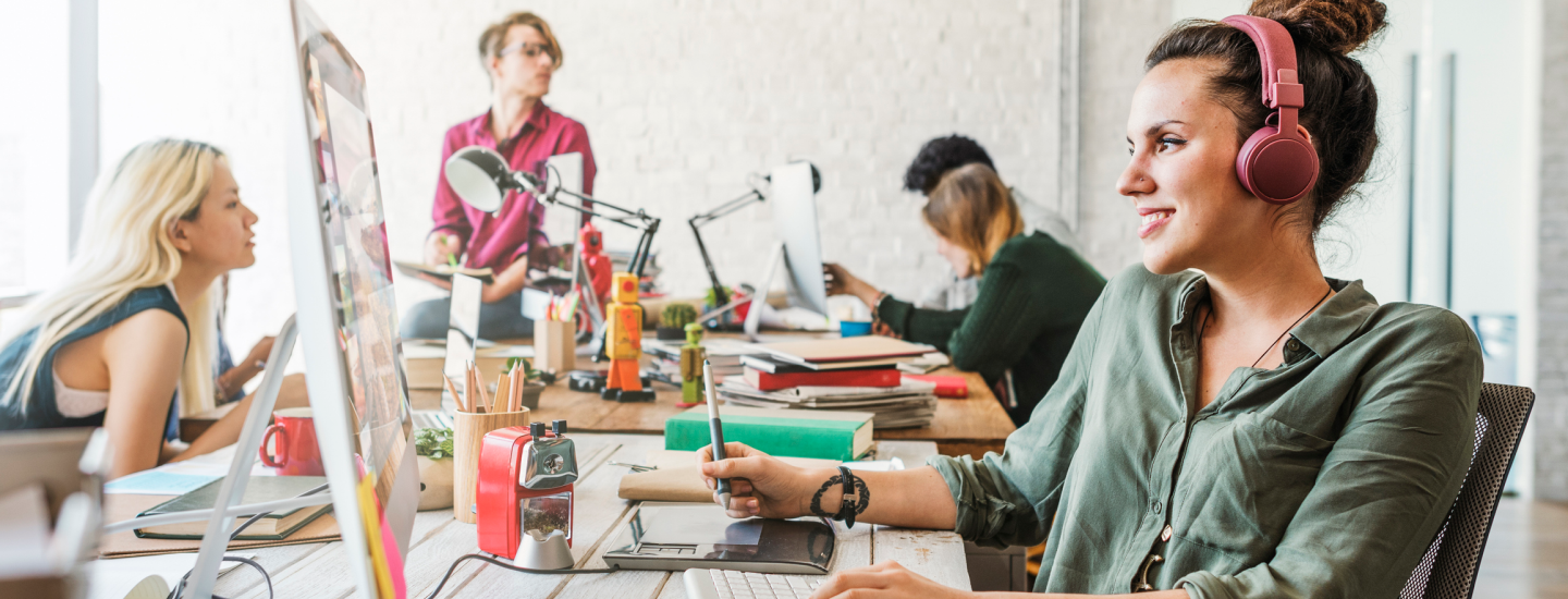 Junge Menschen sitzen in einem Co-Working-Space am Arbeitsplatz